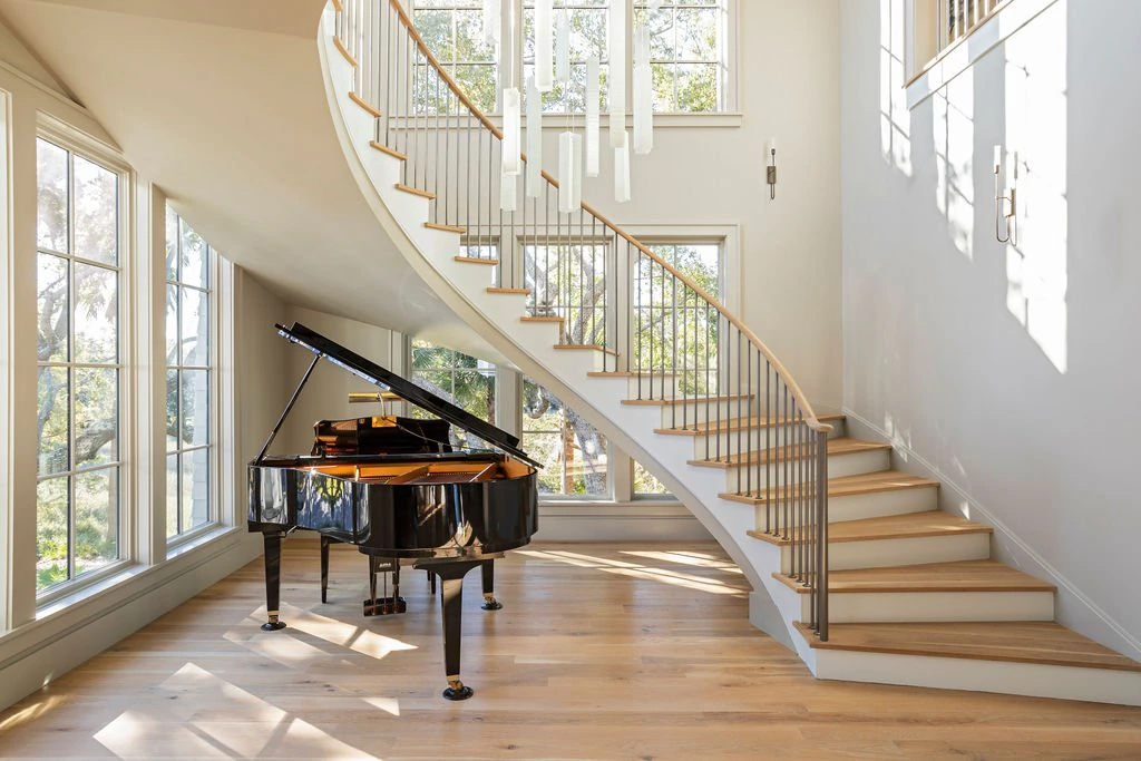 Spiral staircase and grand piano, Isle of Palms interior.