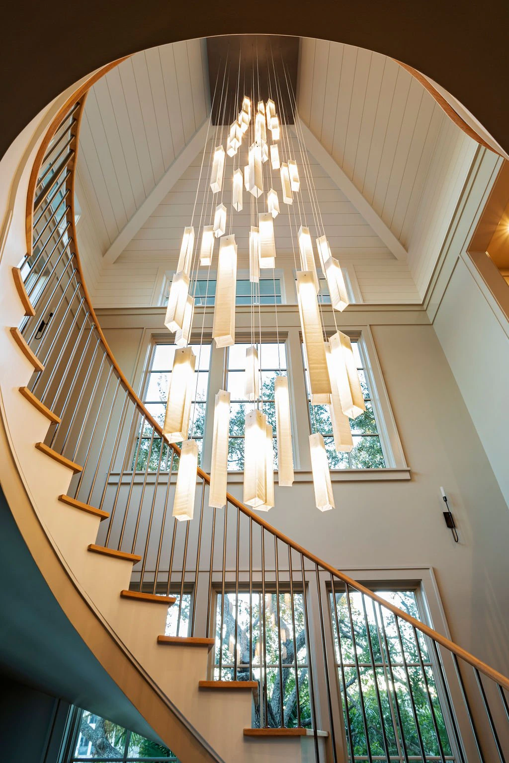 Spiral staircase with chandelier, Isle of Palms residence.